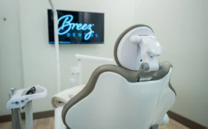 dental chair at breez dental with a tv screen in front