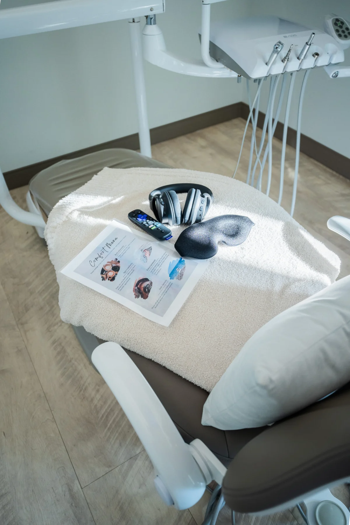 dental chair at breez dental with comfort amenities including headphones, eye mask, and brochure
