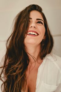 woman with sensitive teeth smiling after teeth whitening Surprise